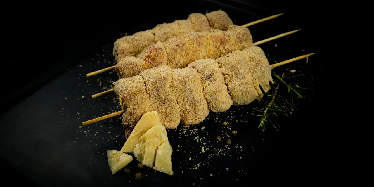 Bombette pugliesi alla brace, impanate e pronte per la cottura, con formaggio e rosmarino.