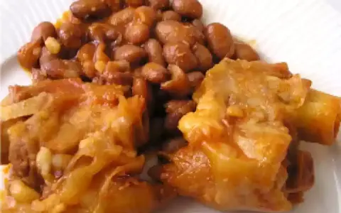 Piatto di zampone con fagioli, un classico della cucina italiana, servito su un piatto bianco.