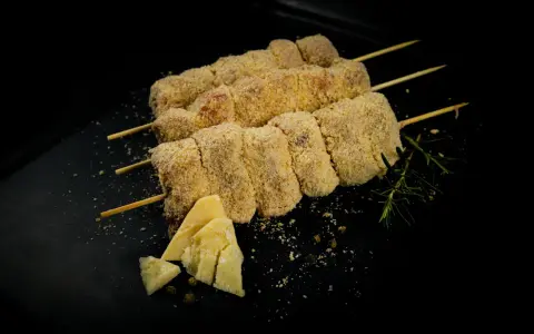 Bombette pugliesi alla brace, impanate e pronte per la cottura, con formaggio e rosmarino.