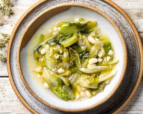 Scarola e fagioli fatto in casa da Benedetta, un piatto semplice e gustoso, servito in una ciotola rustica su un tavolo di legno.