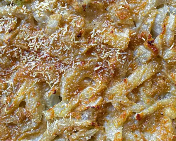 Finoçchi gratinati al forno con besciamella, dorati e croccanti, con formaggio filante e una spolverata di parmigiano.