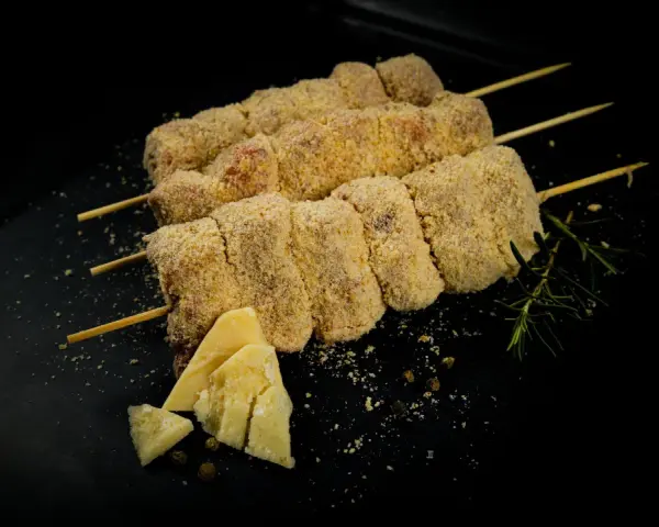 Bombette pugliesi alla brace, impanate e pronte per la cottura, con formaggio e rosmarino.